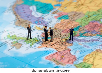 Miniature Business People On Map Of Europe. Macro Photo