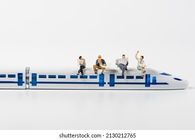 Miniature Business People Sitting On  High Speed Train Model Background