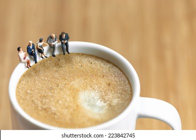 Miniature Business Team Having A Coffee Break. Macro Photo