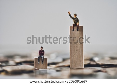 Miniature businessman with disparity society image