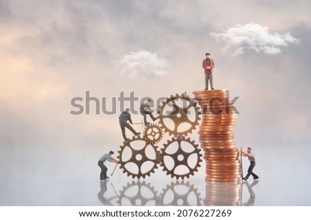 Miniature businessman on top of a pile of coins with construction workers, leadership, success, inequality concept