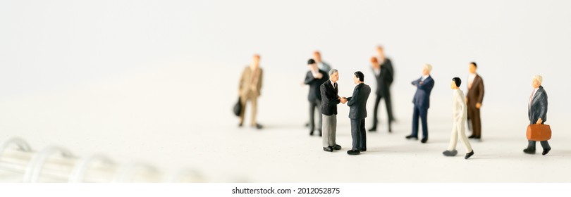 Miniature Businessman Shake Hand Partner Client Customers On Stage With Success Dealing Business Using As Contract Commitment Agreement Investment And Partnership Business Development Cover Page Ads