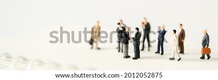 Miniature businessman shake hand partner client customers on stage with success dealing business using as contract commitment agreement investment and partnership business development cover page ads