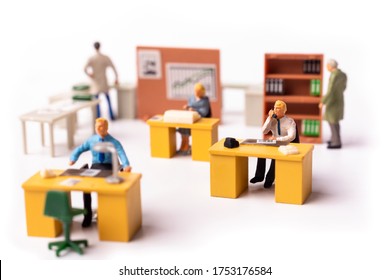 Miniature Businesspeople Team At The Office. Macro Shot Of Tiny People Business Concept. Shallow Dept Of Field