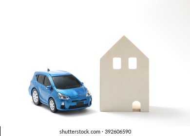 Miniature Car And House On White Background.
