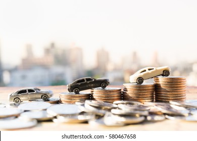 Miniature car model and Financial statement with coins. Finance and car loan, saving money for a car or material design  concepts.