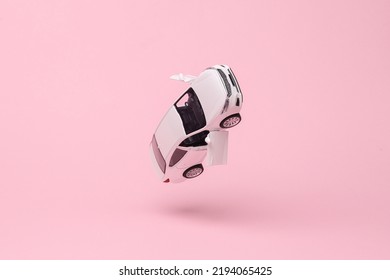 Miniature car model flying in antigravity on pink background with shadow. Levitation object in the air. Creative minimal layout - Shutterstock ID 2194065425