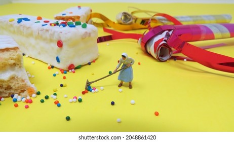 Miniature Cleaning Woman Raking Up Sprinkles After Birthday Party