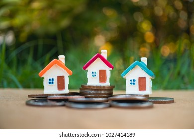Miniature colorful house on stack coins using as property and finance concept