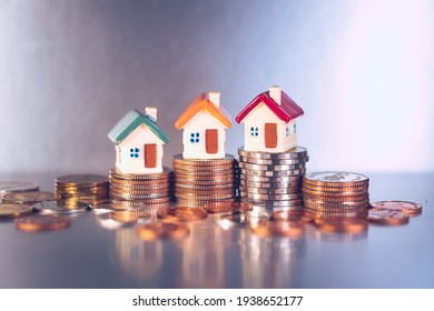 Miniature colorful house on stack coins using as property and financial concept - Shutterstock ID 1938652177