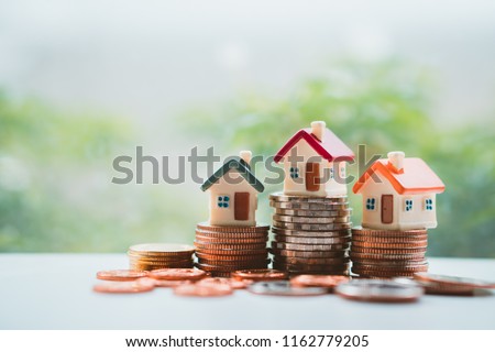 Miniature colorful house on stack coins using as property and financial concept