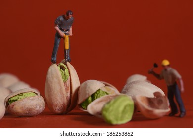 Miniature Construction Workers in Conceptual Food Imagery With Pistachio Nuts - Powered by Shutterstock