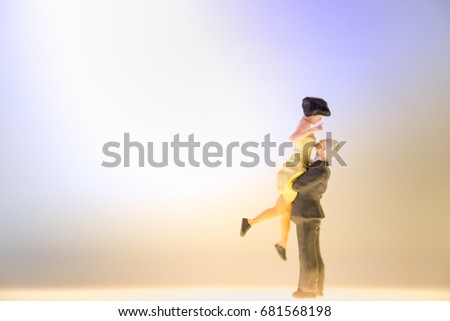 Miniature couple dancing or standing on the shining floor,Love and date concept with copy space