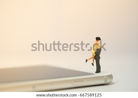 Miniature couple standing on smart phone,Online dating ,Social live concept .copy space