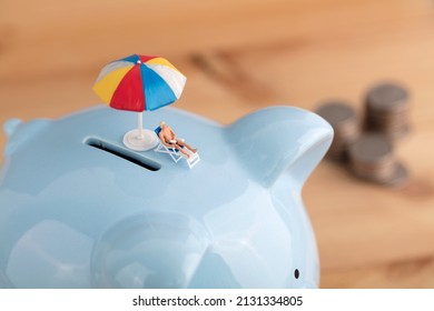 Miniature Creative Sun Umbrella And Easer At The Mouth Of The Piggy Bank