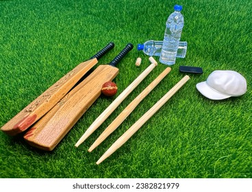 Miniature cricket bat, ball, and stumps on lush grass – versatile for presentations, reports, and cricket-related content. - Powered by Shutterstock