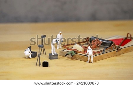 Miniature Crime Investigation Team Photographing a Mouse Trap Accident.
