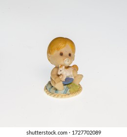 Miniature Depicting A Child Holding A Small Toy Horse In His Hands