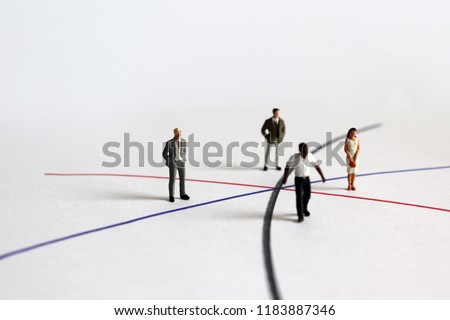 Miniature diverse people standing on different line.