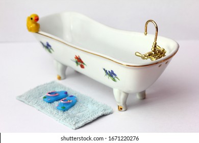 Miniature Doll House Bath With Golden Faucet, Isolated Background.