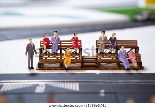 Miniature doll in race track,\
Miniature people watching racing cars in the field. Selective\
focus