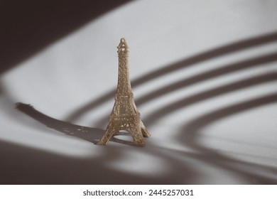 Miniature of Eiffel tower on the table in sunshine.