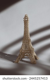 Miniature of Eiffel tower on the table in sunshine.