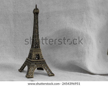 Miniature Eiffel Tower Statue on White Background
A close-up photo of a vintage miniature Eiffel Tower statue. Perfect for home decor, a gift, or a souvenir.