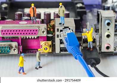 Miniature Engineer Team Try To Connect Ethernet Cables To Port