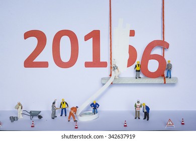 Miniature engineer or technician change represents the new year 2015- 2016