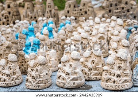 Miniature fairy chimney figurines in neutral shades with pops of turquoise. Cavusin, Avanos, Cappadocia, Turkey (Turkiye)