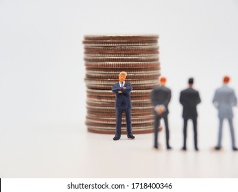 A miniature father standing in front of his sans.Inheritance concept image. - Shutterstock ID 1718400346