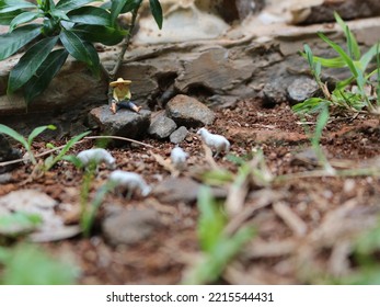 Miniature Figure Of A Goat Herder Resting On A Rock.