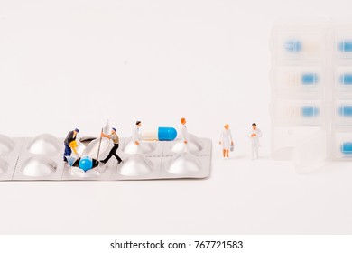 Miniature Figure People Working With Drug Daily Container On White Background,medical Concept