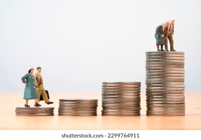 Miniature figure young man and woman walk and Couple Senior Pensioners standing on the top coins stacking for wealth financial planning ,money saving and life insurance of retirement concept.  - Powered by Shutterstock