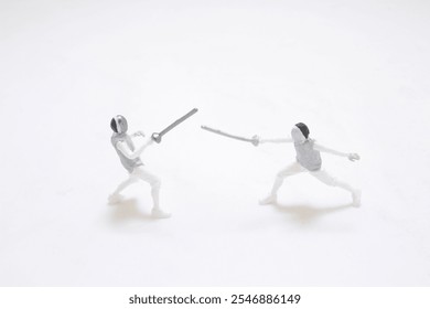 miniature figures capture the dynamics of a fencing duel, showcasing precision - Powered by Shutterstock