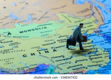 Miniature Figurine Concept : The Businessman Traveling / Standing On MAINLAND CHINA Map Travel Around The World, Business Trip Traveler Adviser Agency Or Online World Wide Marketing Concept.