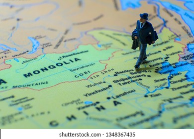 Miniature Figurine Concept : The Businessman Traveling / Standing On MAINLAND CHINA Map Travel Around The World, Business Trip Traveler Adviser Agency Or Online World Wide Marketing Concept.