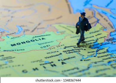 Miniature Figurine Concept : The Businessman Traveling / Standing On MAINLAND CHINA Map Travel Around The World, Business Trip Traveler Adviser Agency Or Online World Wide Marketing Concept.