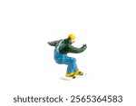 Miniature figurine depicting a snowboarder in mid-motion isolate on white background with clipping path