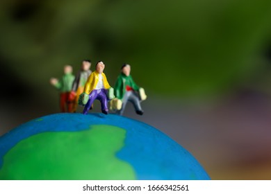 Miniature Figurine Group Of Young Traveler Traveling For Journey People In Trips Abroad Standing On Earth Globe Green Model, Business Trip Travel Advisor Agency Online In World Wide For Vacation