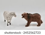 miniature figurine toy bear pointing at a sheep