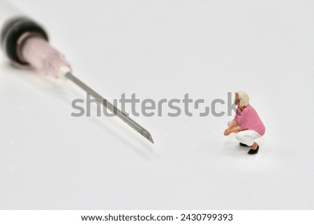 miniature figurine of a woman with a syringe