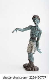 miniature figurine of a zombie doll on a white background 