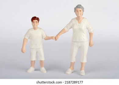miniature figurines of a grandma with her nephew child - Shutterstock ID 2187289177