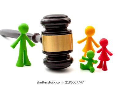 Miniature Figurines Representing Father, Mother And Children Separated By Judge Gavel Concept For Family Law Ruling, Joint Parental Child Custody, Verdict In Legal Court And Painful Divorce Dispute