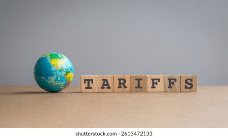 Miniature globe next to message, Tarriffs on square wooden blocks.