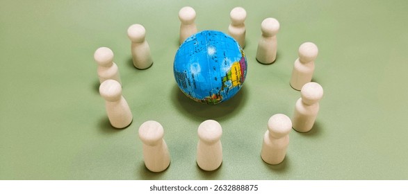 Miniature Globe Surrounded by Multiple Wooden Dolls Representing Global Unity, World Community, International Diversity, and Human Connection Across All Nations. 