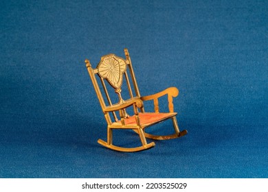 Miniature Gold Metal Rocking Chair With Red Velvet Seat.