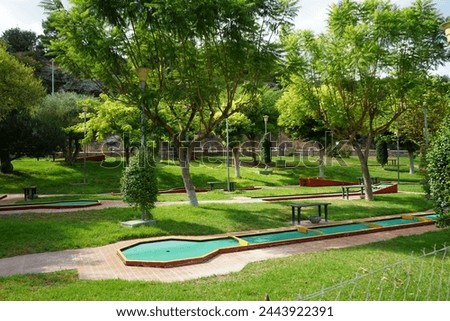 Miniature golf in Lardos. Miniature golf, minigolf, putt-putt, crazy golf, and by several other names is an offshoot of the sport of golf focusing solely on the putting aspect of its parent game. 